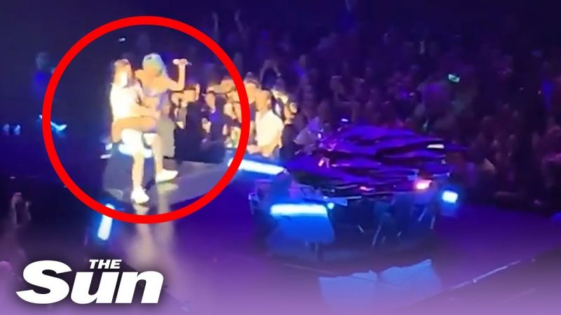 Lady Gaga falls off stage after fan drops her